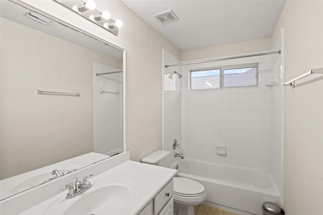 full bathroom featuring tile patterned floors, vanity, toilet, and tiled shower / bath combo