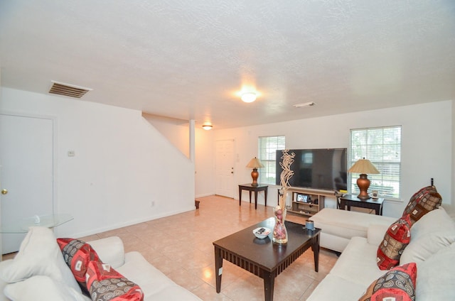 living room with a healthy amount of sunlight and a textured ceiling