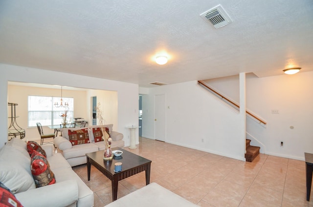 living room featuring a notable chandelier and light tile patterned flooring