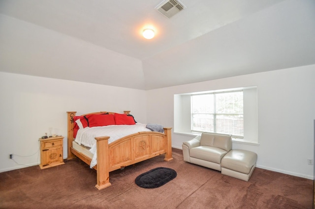 bedroom with lofted ceiling and dark carpet