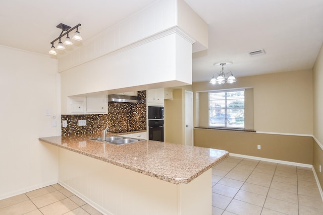 kitchen with a peninsula, visible vents, white cabinetry, black appliances, and decorative light fixtures