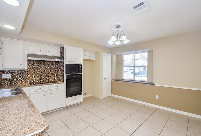 kitchen with visible vents, white cabinets, decorative light fixtures, under cabinet range hood, and black appliances