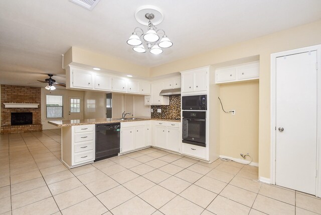 kitchen with black appliances, a peninsula, light tile patterned flooring, and white cabinets