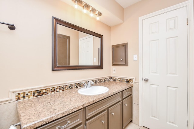 bathroom with wainscoting, vanity, and tile walls