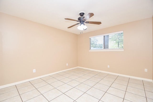 unfurnished room featuring a ceiling fan and baseboards