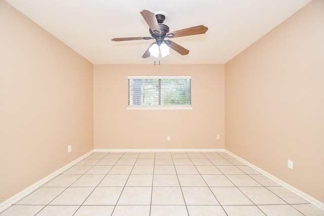 spare room with ceiling fan and baseboards