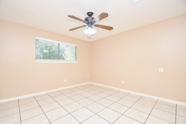 spare room featuring a ceiling fan and baseboards