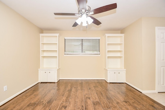 unfurnished bedroom featuring a ceiling fan, baseboards, and wood finished floors