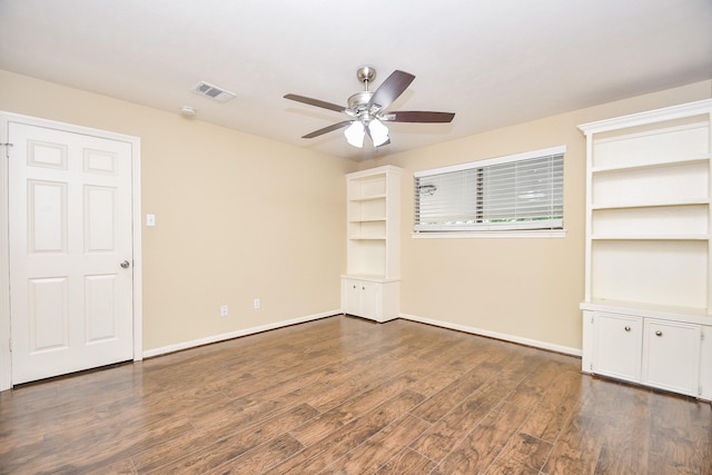 unfurnished room featuring a ceiling fan, baseboards, visible vents, and dark wood-type flooring