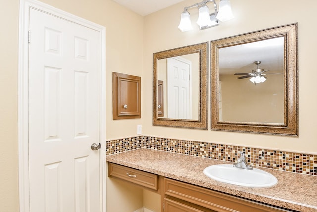 bathroom featuring a ceiling fan, backsplash, and vanity