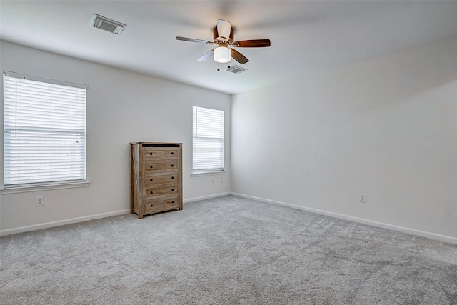 carpeted spare room featuring ceiling fan