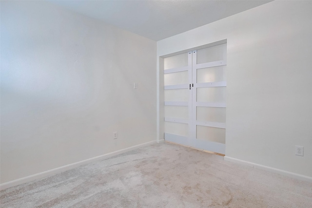 carpeted empty room featuring built in features