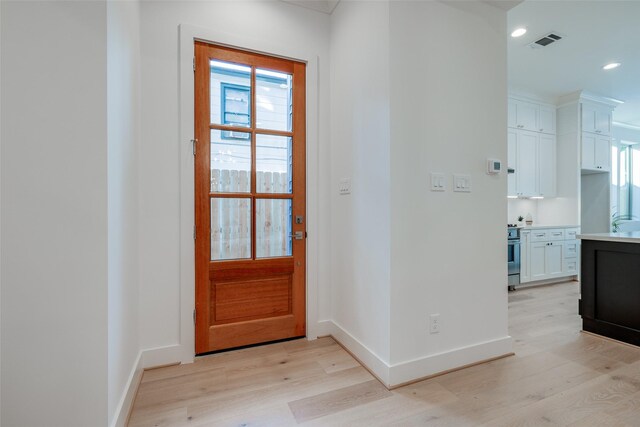 doorway to outside with light wood-type flooring