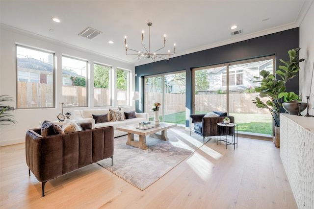 interior space with a chandelier, crown molding, and light hardwood / wood-style floors