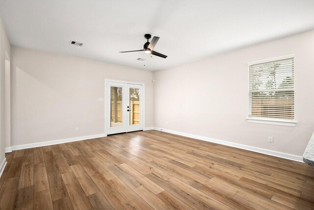 spare room featuring a wealth of natural light, ceiling fan, and light wood-type flooring