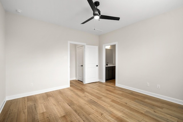 unfurnished bedroom with connected bathroom, light hardwood / wood-style flooring, and ceiling fan