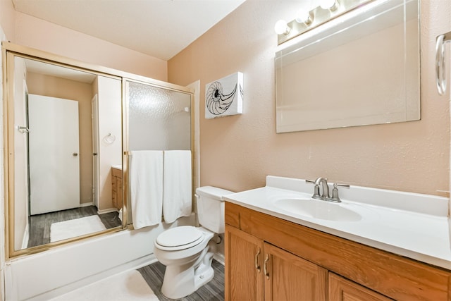 full bathroom featuring vanity, toilet, and bath / shower combo with glass door