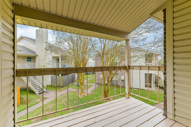 wooden terrace with a lawn