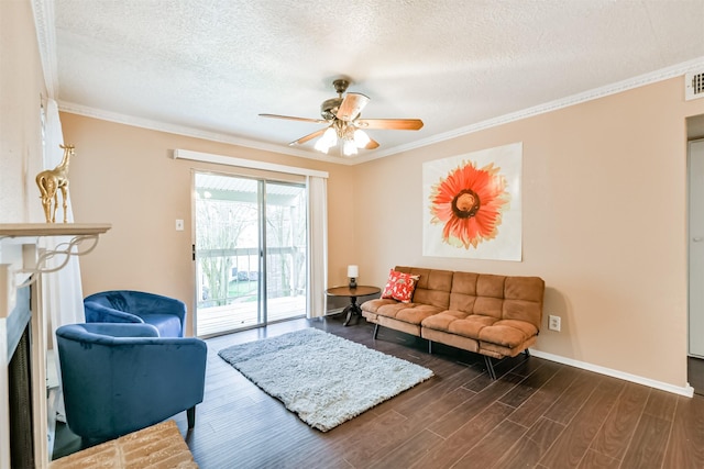 living room featuring a textured ceiling, dark hardwood / wood-style flooring, ceiling fan, and crown molding