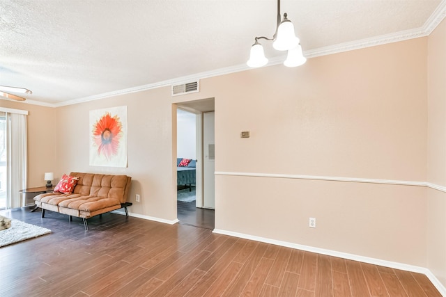 unfurnished room featuring crown molding, hardwood / wood-style floors, and a textured ceiling