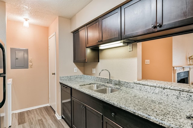 kitchen featuring dishwasher, electric panel, sink, dark brown cabinets, and light stone counters