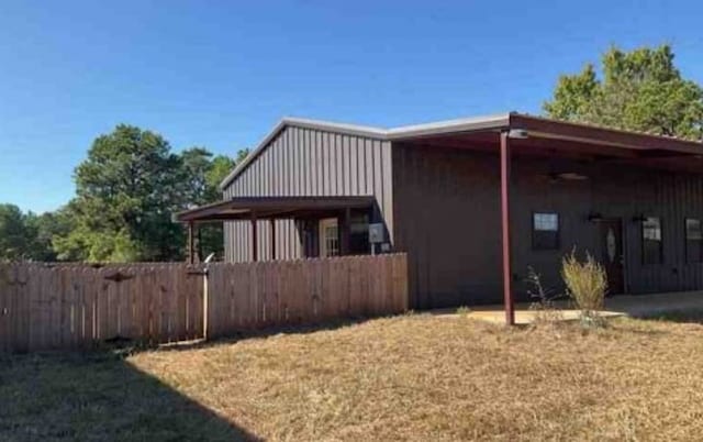 view of side of home featuring a yard