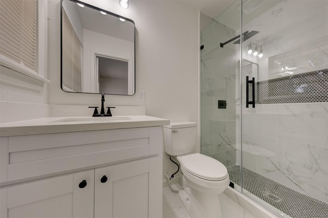 bathroom with vanity, toilet, and a shower with shower door