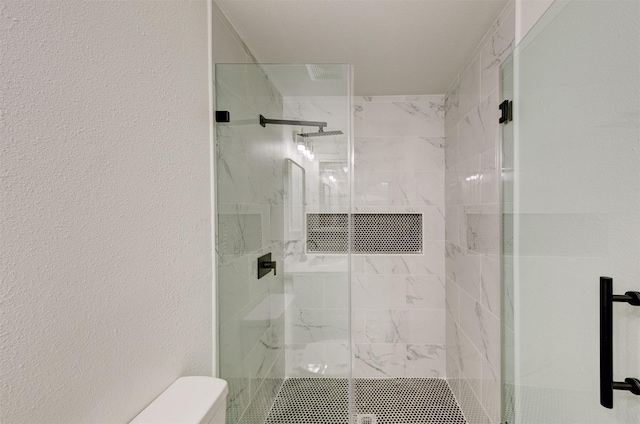 bathroom with toilet and walk in shower