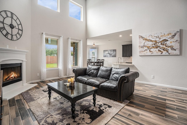 living room with a high ceiling and sink