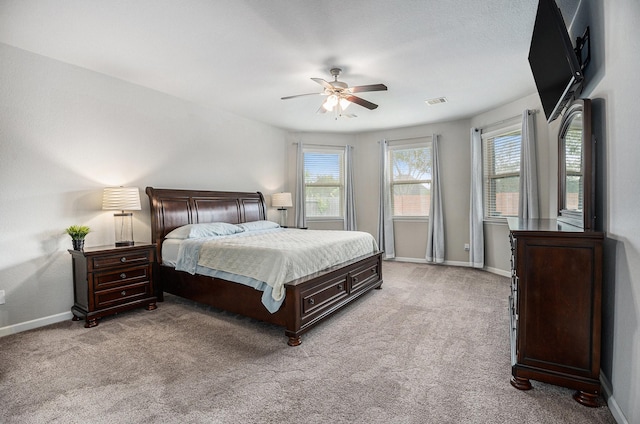 bedroom with ceiling fan and light carpet