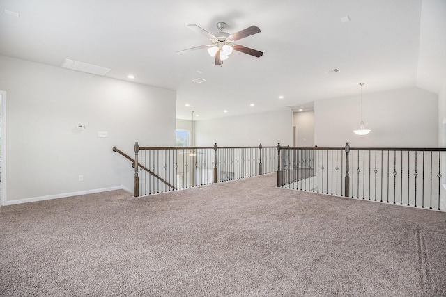 carpeted spare room featuring vaulted ceiling and ceiling fan