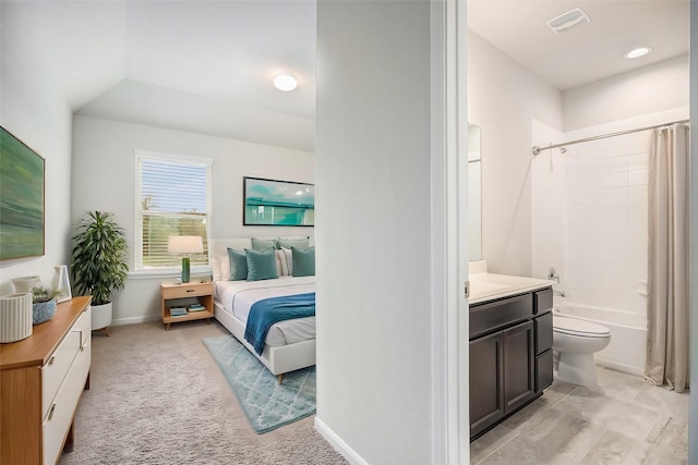 bedroom with light colored carpet and vaulted ceiling