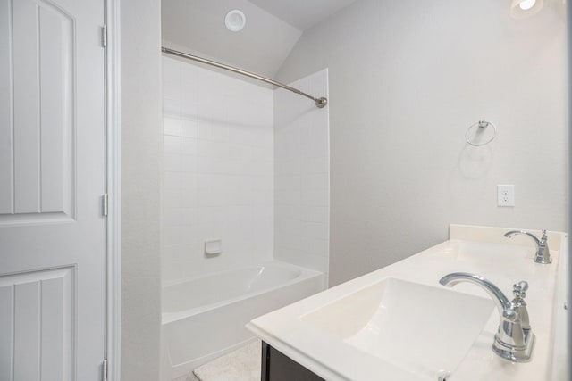 bathroom with vanity, shower / washtub combination, and vaulted ceiling