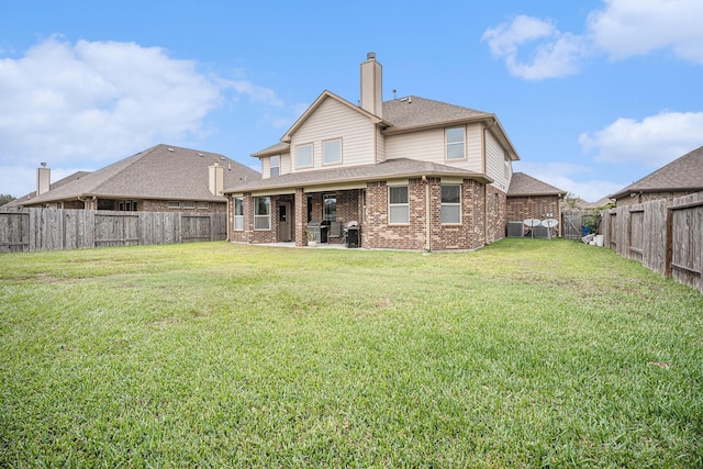 rear view of property with a yard