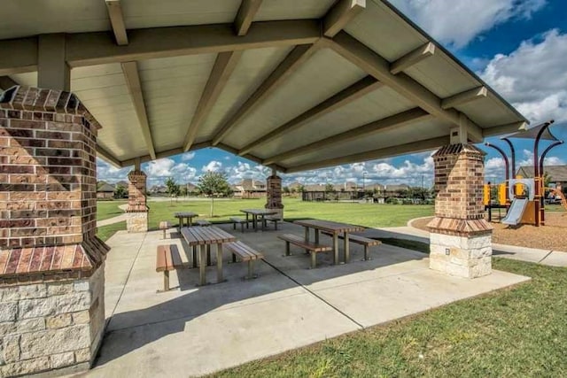 view of community with a lawn and a patio