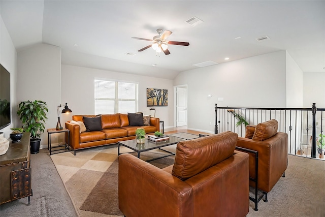 carpeted living room with ceiling fan and lofted ceiling