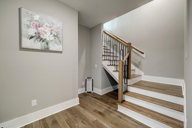 stairs with hardwood / wood-style flooring