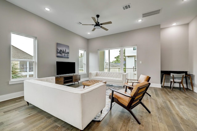 living room featuring ceiling fan and light wood-type flooring