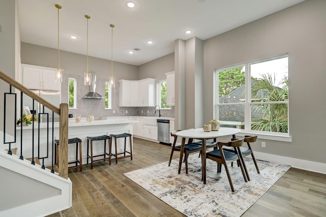 dining space with dark hardwood / wood-style flooring and sink