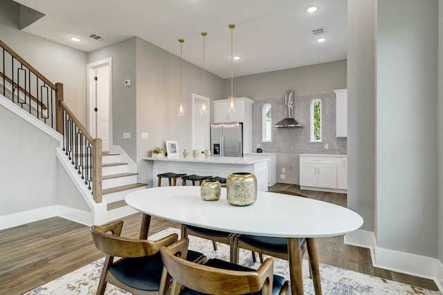 dining space featuring wood-type flooring