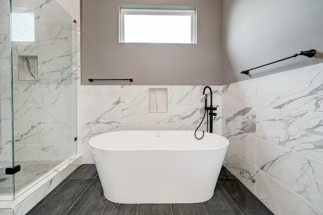 bathroom with plus walk in shower and tile walls