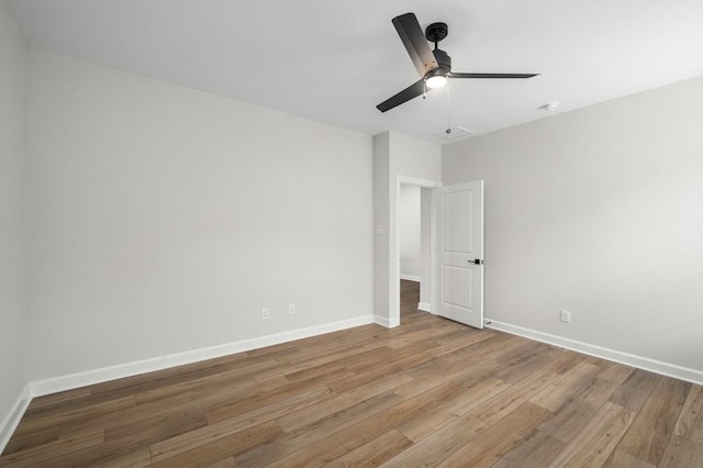 empty room with ceiling fan and hardwood / wood-style flooring