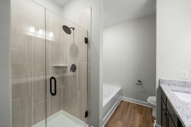 full bathroom featuring wood-type flooring, vanity, shower with separate bathtub, and toilet