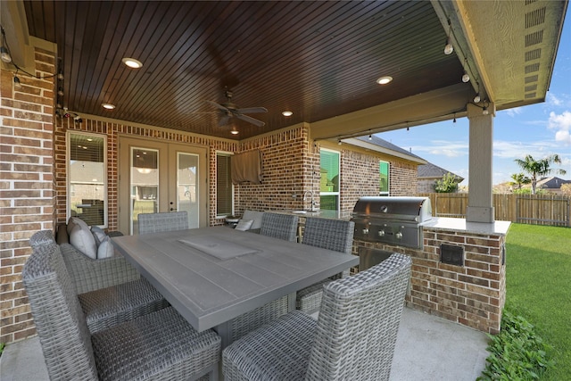 view of patio with sink, area for grilling, ceiling fan, and a grill