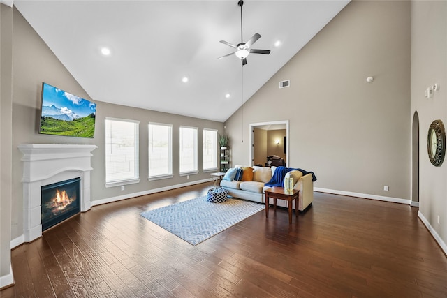 living room featuring ceiling fan, dark hardwood / wood-style flooring, and high vaulted ceiling