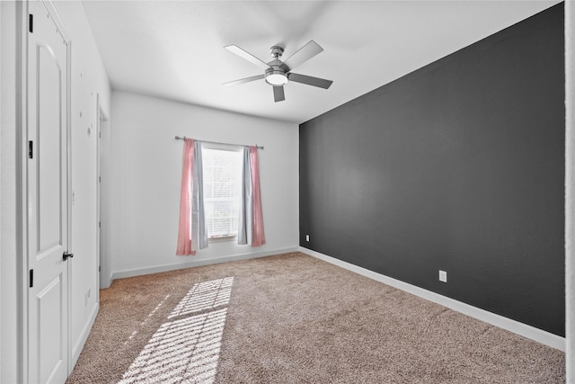 unfurnished bedroom with ceiling fan and carpet