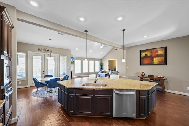 kitchen featuring ceiling fan, french doors, sink, stainless steel appliances, and a center island with sink