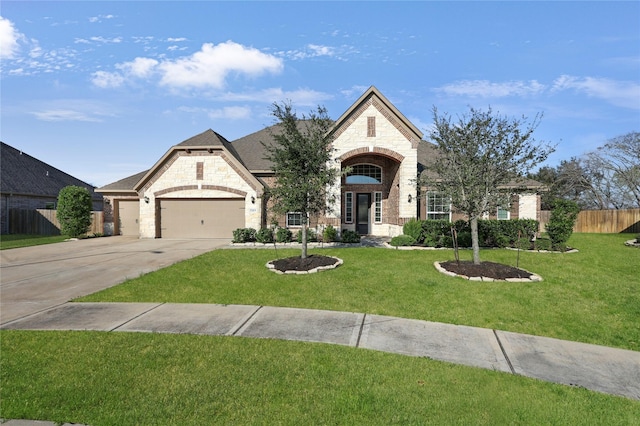 french country style house with a front lawn and a garage