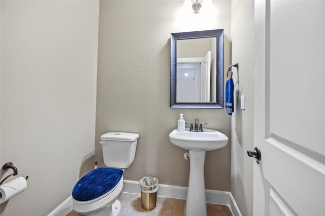 bathroom with tile patterned floors, sink, and toilet