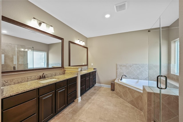 bathroom with vanity and separate shower and tub